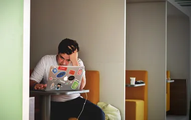 Man looking at laptop in frustration
